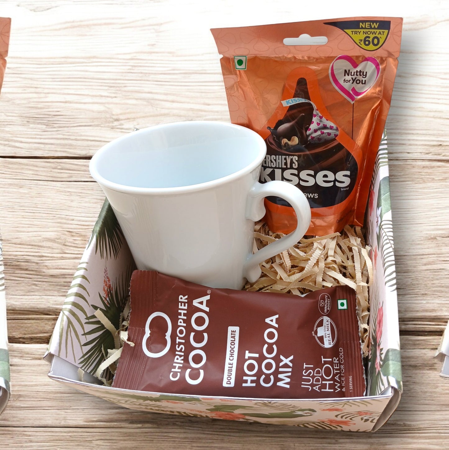 Mini gift hamper box with an elegant coffee mug, pack of hot cocoa and a pack of Hershey's kisses